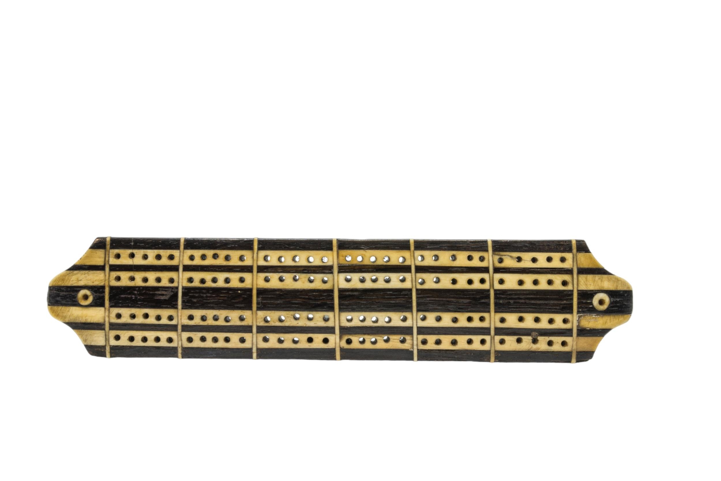 OLD LONDON BRIDGE INTERESTA wood and bone cribbage board, with label to ...