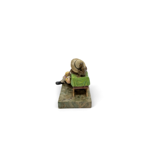 443 - A 19TH CENTURY FIGURAL GROUPA boy sleeping next to a performing monkey, 13cms wide