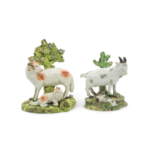 452 - A PEARLWARE BOCAGE GROUP OF A SHEPHERDESS AND SHEEPEarly 19th century, together with a pair of sheep... 