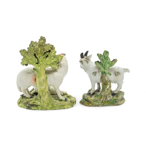 452 - A PEARLWARE BOCAGE GROUP OF A SHEPHERDESS AND SHEEPEarly 19th century, together with a pair of sheep... 