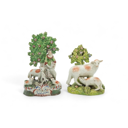 452 - A PEARLWARE BOCAGE GROUP OF A SHEPHERDESS AND SHEEPEarly 19th century, together with a pair of sheep... 