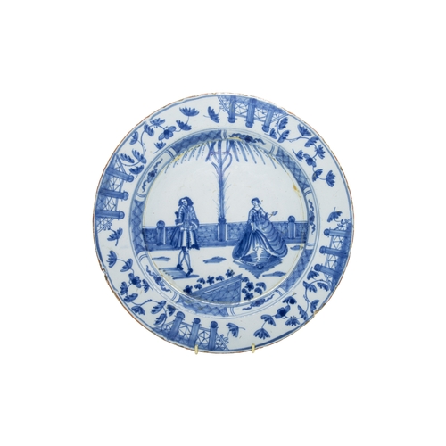 296 - TWO DELFT CHARGERSMid 18th century, once with two figures in European dress, together with a delft b... 