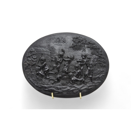 332 - A WEDGWOOD OVAL BASALT PLAQUECirca 1780, moulded with bacchantes in a landscape, together with two f... 