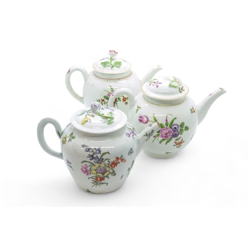 499 - THREE ENGLISH 18TH CENTURY TEAPOTSDecorated with floral sprigs, 12cms high.