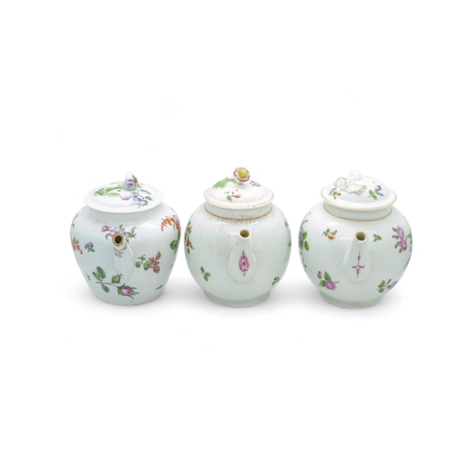 499 - THREE ENGLISH 18TH CENTURY TEAPOTSDecorated with floral sprigs, 12cms high.