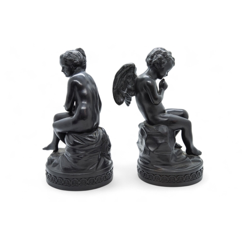 537 - A PAIR OF WEDGWOOD BASALT FIGURES CUPID AND PSYCHE18th / 19th century, 21cms high.