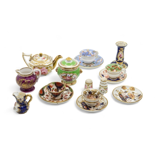 402 - A COLLECTION OF MINIATURESA Spode claret ground jug with raised paste gilding, a teapot, two thimble... 