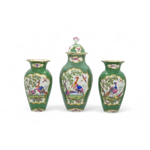 337 - A WORCESTER GREEN GROUND FANCY BIRDS GARNITURECirca 1775, comprising a covered vase and two baluster... 