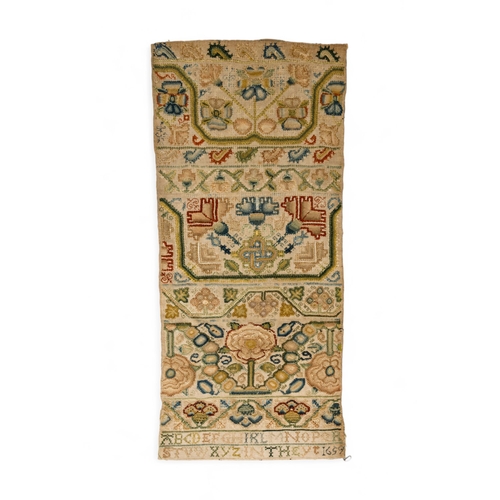 A 17TH CENTURY BAND SAMPLER the finely executed work with panels of flowers and meandering bands of floral motifs with an alphabet at the base and ‘In The Yr 1659’.