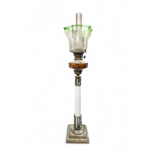 68 - A VICTORIAN OIL LAMP with milk glass column upon a brass base with red glass reservoir and etched gl... 