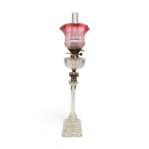 61 - A VICTORIAN OIL LAMP, the hexagonal glass column with metal Corinthian column top with cut glass res... 