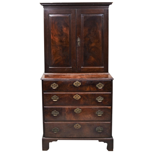 610 - A GOOD GEORGE III MAHOGANY CABINET ON CHEST CIRCA 1760 with a moulded cornice above two folded panel... 