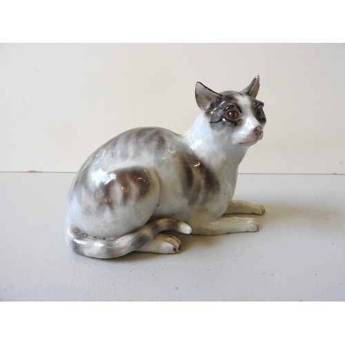 612 - A MEISSEN CAT19th CENTURYthe seated cat decorated with shades of brown,10cms high