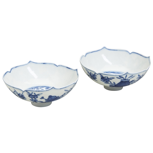 95 - A PAIR OF BLUE AND WHITE FLOWER-HEAD FORM DISHES20TH CENTURY painted with auspicious symbols of the ... 