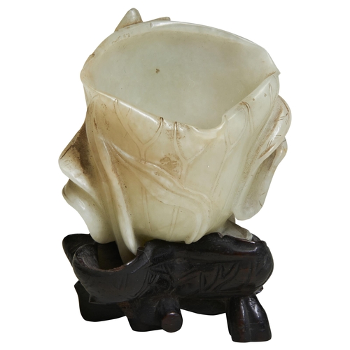 291 - A CARVED WHITE JADE 'LOTUS LEAF' BRUSH WASHERQING DYNASTY, 18TH / 19TH CENTURYof naturalistic form, ... 