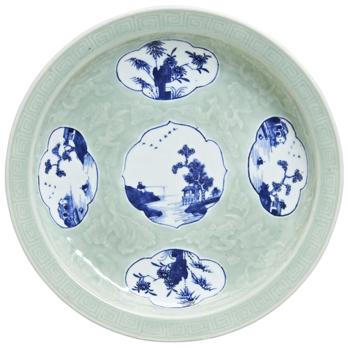 181 - AN UNDER-GLAZED BLUE CELADON-GROUND 'LANDSCAPES' DISHQING DYNASTY, 19TH CENTURYthe circular dish wit... 