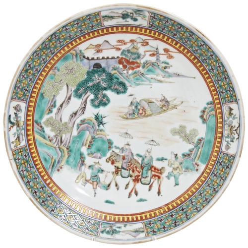 126 - A FAMILLE VERTE CHARGER QING DYNASTY, 19TH CENTURYdecorated with a figural mountain landscape scene ... 