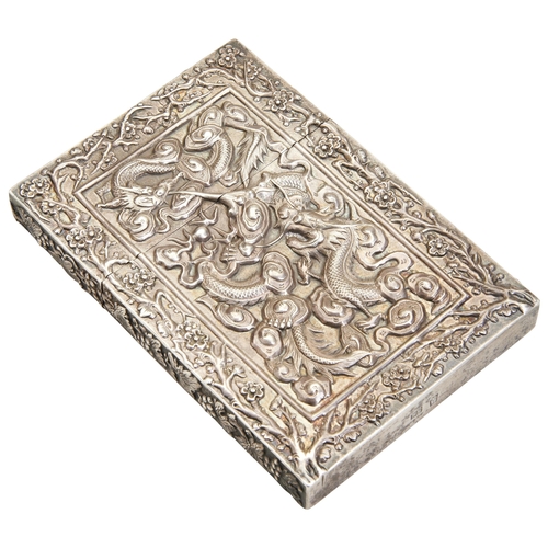 313 - A CHINESE EXPORT SILVER CARD CASECANTON, CIRCA 1900decorated in relief with two scaly dragons to one... 