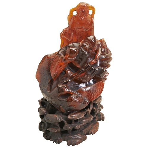 288 - A CARVED AMBER FIGURE OF DAOIST IMMOTALS19TH/20TH CENTURY carved Daoist immortal 'Shoulao' holding a... 