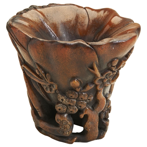 355 - A CARVED RHINOCEROS HORN 'THREE WINTER FRIENDS' LIBATION CUPQING DYNASTY, 19TH CENTURY 清 十九世纪 “岁寒三友”... 