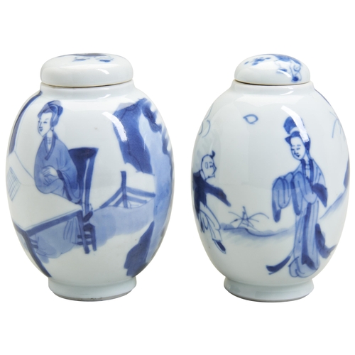 104 - A MATCHED PAIR OF KANGXI COVERED CADDIESKANGXI PERIOD (1662-1722) depicting a garden scene of lady a... 