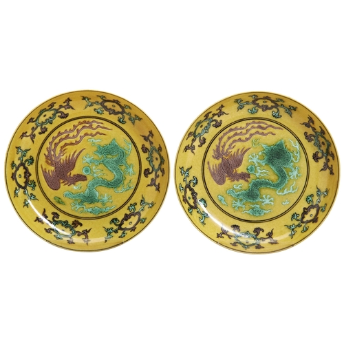 214 - A PAIR YELLOW-GROUND GREEN-AN-AUBERGINE-GLAZED 'DRAGON & PHOENIX' DISHES19TH / 20TH CENTURYeach ... 