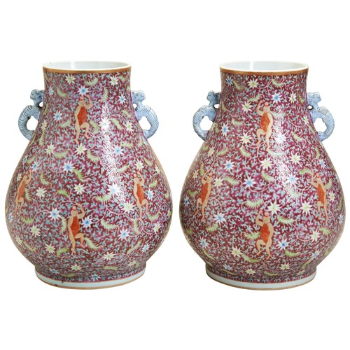 148 - A PAIR OF FAMILLE ROSE PINK-GROUND 'BOYS' VASES, HULATE QING / REPUBLIC PERIOD清 粉彩童子持莲瓶一对the pear-sh... 