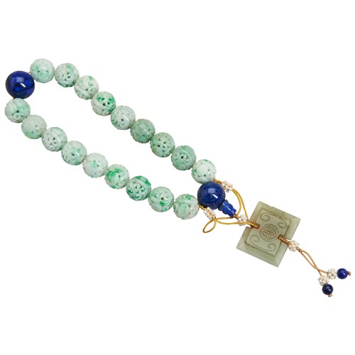 280 - A JADE BRACELET 20TH CENTURY carved eighteen jadeite beads with two lapis lazuli beads.