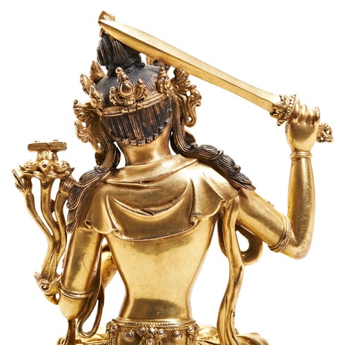 14 - A FINE GILT BRONZE FIGURE OF MANJUSHRIYONGLE SIX CHARACTER MARK AND PROBABLY OF THE PERIOD 明 铜鎏金文殊造像... 
