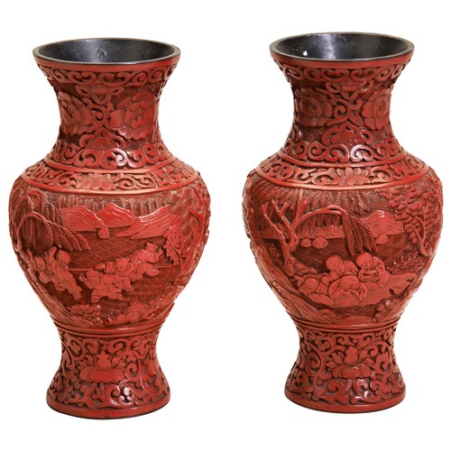 380 - A PAIR OF CINNABAR LACQUER VASESLATE QING DYNASTYthe baluster sides deeply carved with playful boys ... 