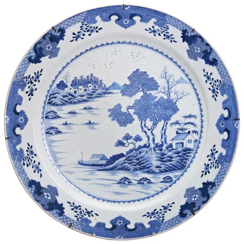 103 - A LARGE CHINESE EXPORT BLUE AND WHITE 'LANDSCAPES' CHARGERQIANLONG PERIOD (1736-1795)painted with a ... 