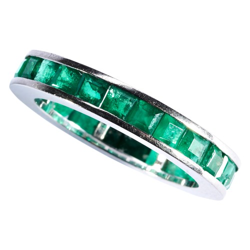 326 - AN ART DECO EMERALD RING, CIRCA 1930channel set with step-cut emeralds.Total weight 5.2gmsRing size ... 