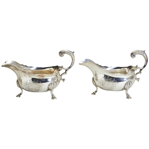 87 - A PAIR OF GEORGE III SAUCE BOATS, LONDON 1761. Each one engraved with a full armorial. Made by David... 