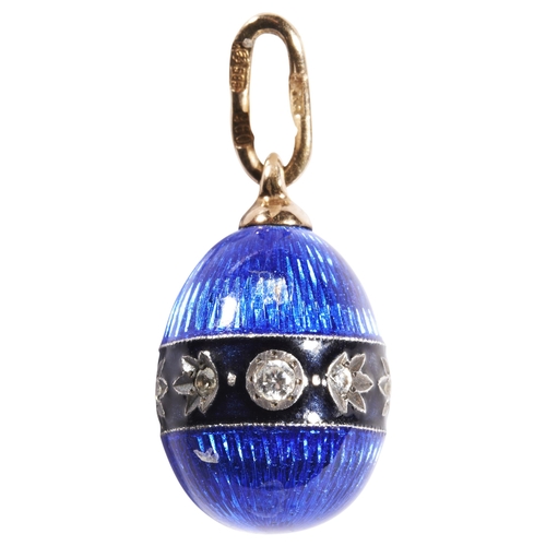 322 - A DIAMOND AND ENAMEL EGG PENDANT, CIRCA 1900blue guilloche enamel egg with a band of white stones.On... 