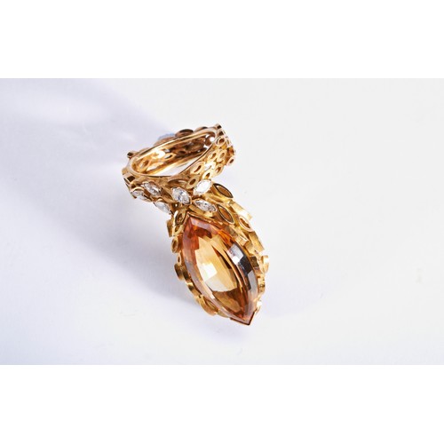 313 - A CITRINE, GOLD AND DIAMOND RINGthe marquise-cut citrine within a gold mount composed of marquise sh... 