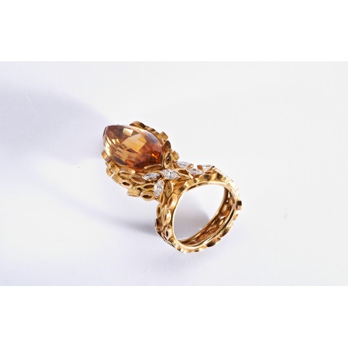 313 - A CITRINE, GOLD AND DIAMOND RINGthe marquise-cut citrine within a gold mount composed of marquise sh... 