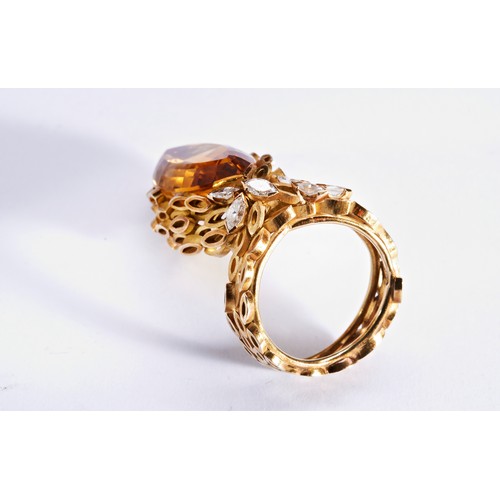 313 - A CITRINE, GOLD AND DIAMOND RINGthe marquise-cut citrine within a gold mount composed of marquise sh... 