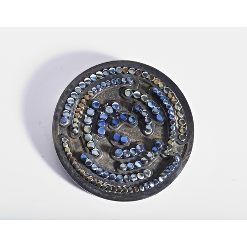 317 - A SILVER AND TITANIUM BROOCH, CIRCA 1960the circular plaque with raised circular mounts of varying c... 