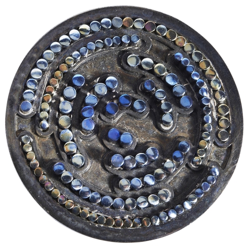 317 - A SILVER AND TITANIUM BROOCH, CIRCA 1960the circular plaque with raised circular mounts of varying c... 