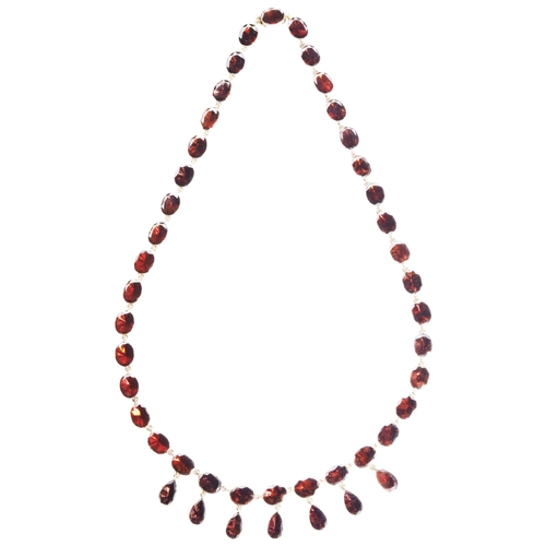 219 - A GARNET AND GOLD NECKLACE, CIRCA 1840-50the uniform row of oval flat-cut garnets, in closed back co... 