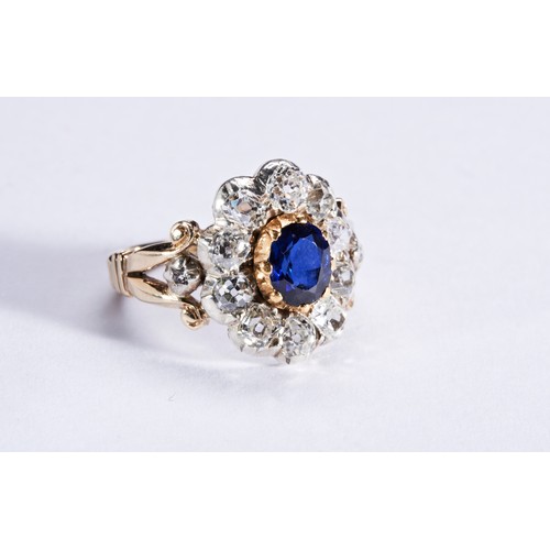 345 - A SAPPHIRE AND DIAMOND RING, CIRCA 1880the oval mixed-cut sapphire, cut down collet set, within a bo... 