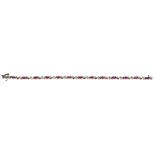 269 - A RUBY AND DIAMOND BRACELETthe thirteen oval mixed-cut rubies, four claw set between pairs of diamon... 