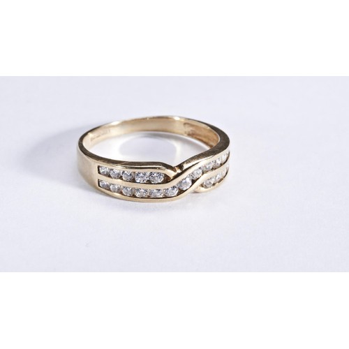 271 - A DIAMOND RINGthe cross over design ring channel set with brilliant-cut diamonds.Hallmarked for 9 ca... 