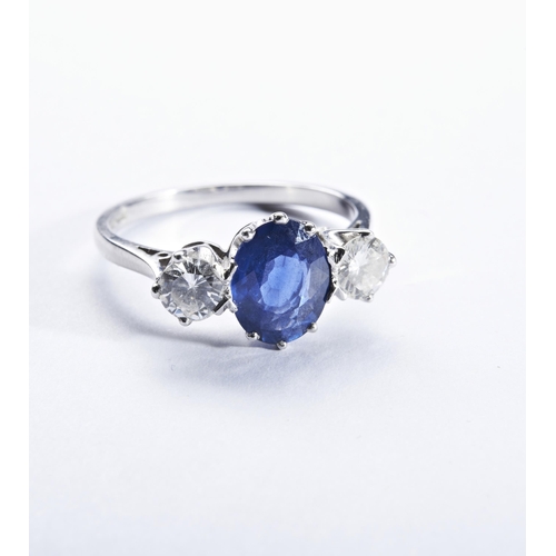 329 - A SAPPHIRE AND DIAMOND THREE STONE RINGthe oval mixed-cut sapphire,  set between brilliant-cut diamo... 