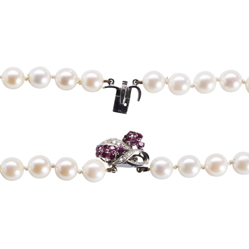 281 - A CULTURED PEARL NECKLACE WITH RUBY AND DIAMOND CLASP the two uniform rows of cultured pearls on a r... 