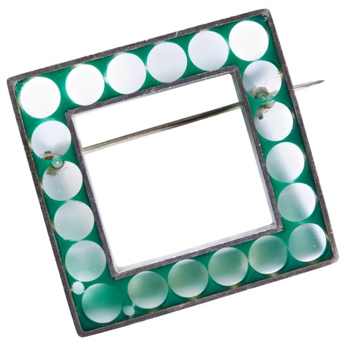 316 - NUALA JAMISON; AN ACRYLIC AND SILVER BROOCHThe square brooch of clear acrylic with green circles.Bro... 