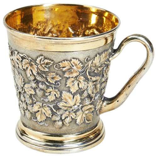 118 - A SILVER GILT MUG BY HUNT & ROSKELL, LONDON 1881. With a naturalistic 'wooden' handle. Embossed ... 