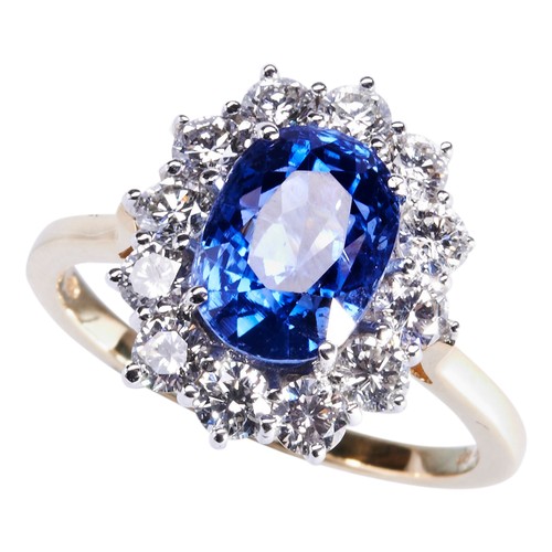 289 - A SAPPHIRE AND DIAMOND RINGthe oval cut sapphire four claw set within a bezela of twelve brilliant-c... 