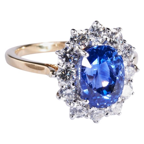 289 - A SAPPHIRE AND DIAMOND RINGthe oval cut sapphire four claw set within a bezela of twelve brilliant-c... 