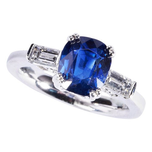 290 - A SAPPHIRE AND DIAMOND RINGthe cushion-cut sapphire four double claw set between baguette-cut diamon... 